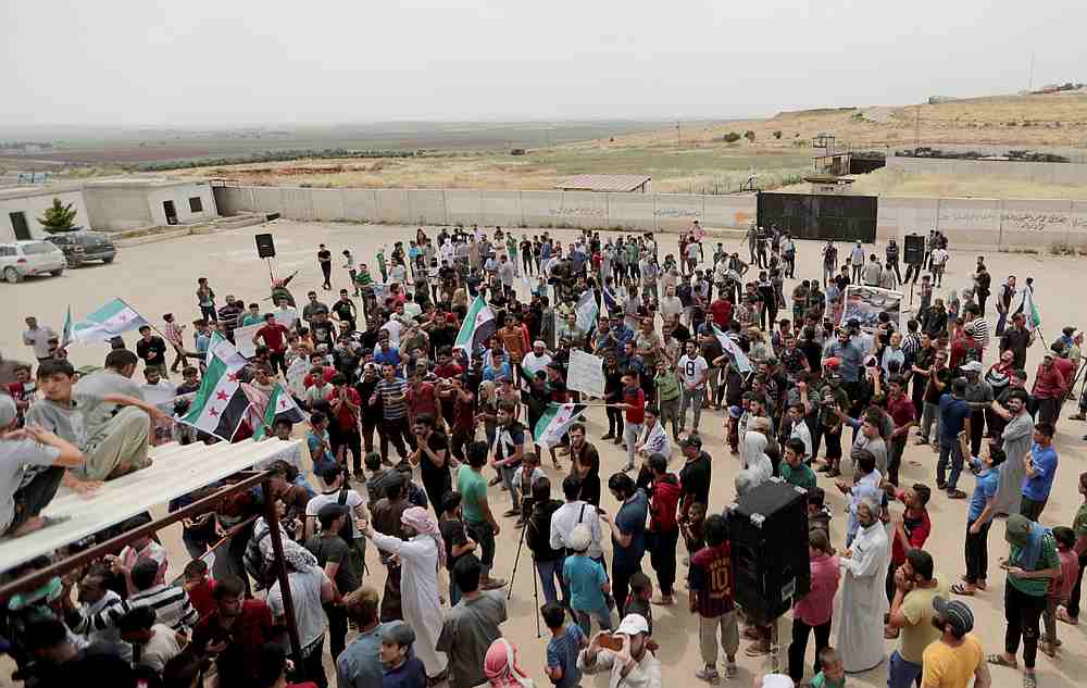 Displaced Syrians gather during a protest calling for an end to the strikes and for Ankara to open the frontier at the Atmeh crossing on the Syrian-Turkish border, in Idlib governorate, Syria May 31, 2019. u00e2u20acu201d Reuters pic