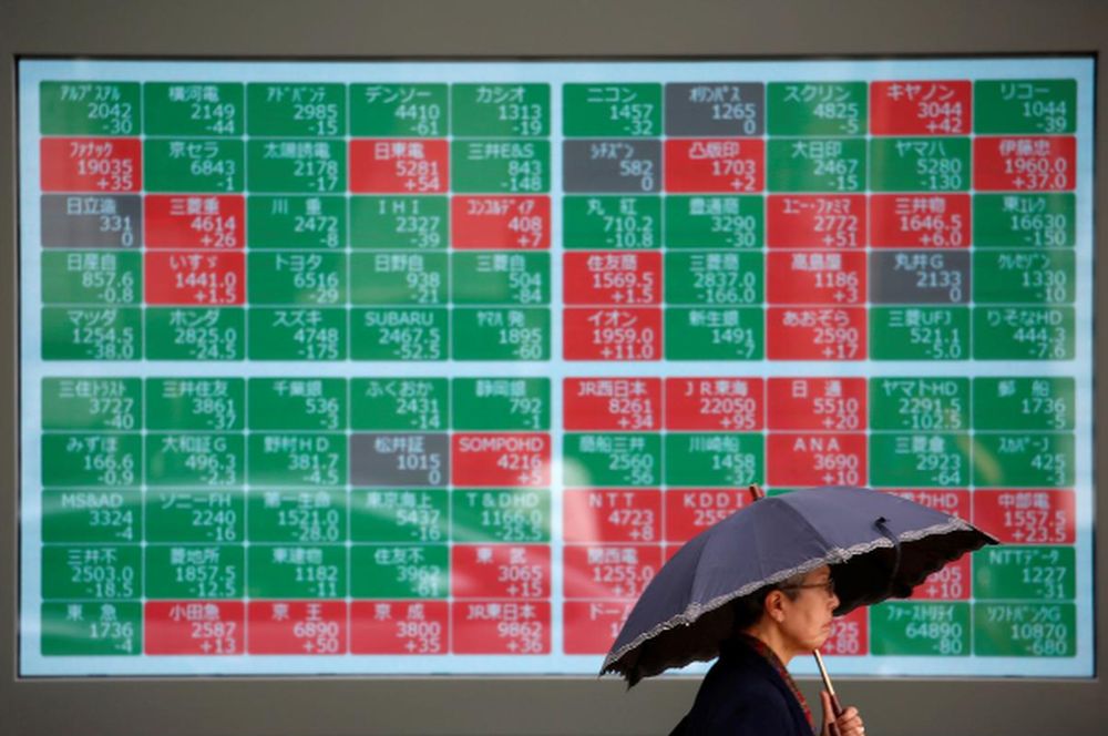 A passerby walks past in front of a stock quotation board outside a brokerage in Tokyo, Japan, May 10, 2019. u00e2u20acu201d Reuters pic