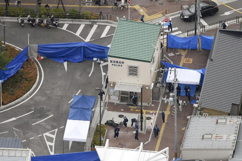 An aerial view shows police officers investigating the site where a police officer was found stabbed in front of a police box in Suita, Osaka prefecture, Japan June 16, 2019. u00e2u20acu201dKyodo/via Reuters