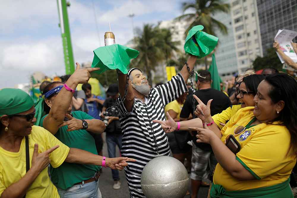 A man uses a mask, depicting former Brazilian president Luiz Inacio Lula da Silva, during a pro-government demonstration near Copacabana beach in Rio de Janeiro, Brazil May 26, 2019. u00e2u20acu201d Reuters pic