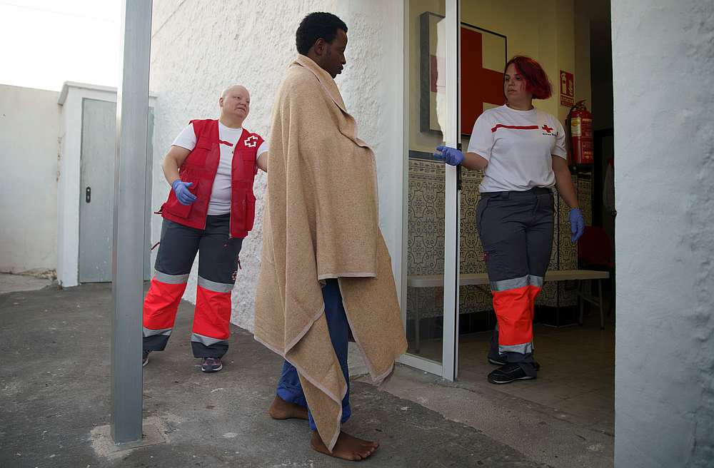 A migrant, rescued by the ferry Vronskiy off the coast in the Mediterranean Sea, walks as he is helped by Red Cross members after arriving at the port of Motril, southern Spain June 19, 2019. u00e2u20acu201d Reuters pic
