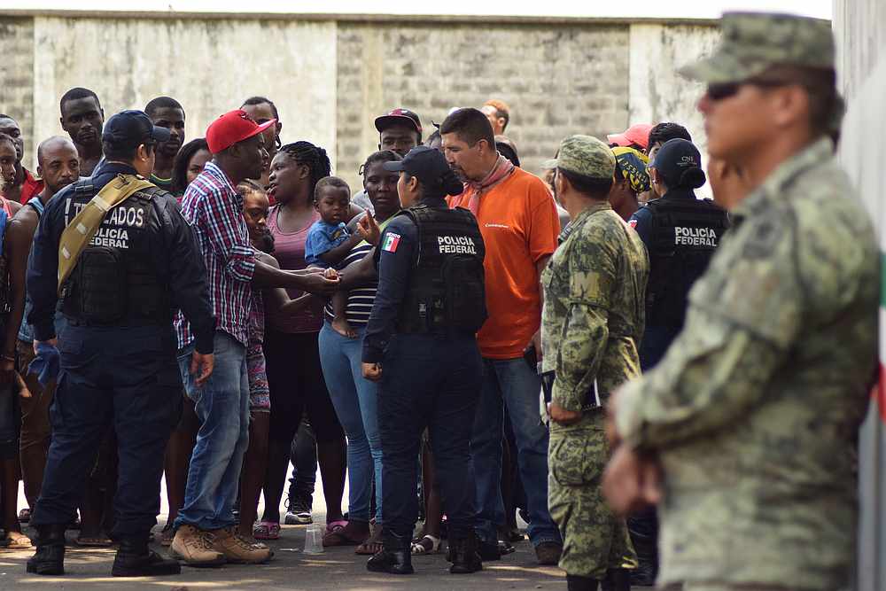 Migrants talk to police officers as soldiers, assigned to the newly created National Guard, keep watch outside the Siglo XXI immigrant detention centre in Tapachula, Mexico May 23, 2019. u00e2u20acu201d Reuters pic 