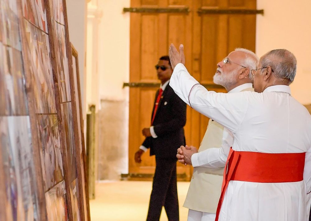 Archbishop of Colombo Cardinal Malcolm Ranjith (right) gestures next to Indian Prime Minister Narendra Modi during Modiu00e2u20acu2122s unscheduled stop at St. Anthonyu00e2u20acu2122s Church in Colombo. u00e2u20acu201d Handout / Sri Lankan Presidential Media Division/AFP pic