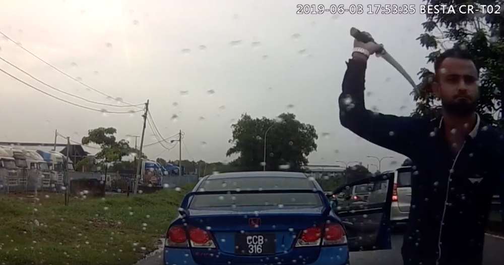A screengrab from YouTube of a man attacking a car with a parang along the Pasir Gudang Highway June 3, 2019.