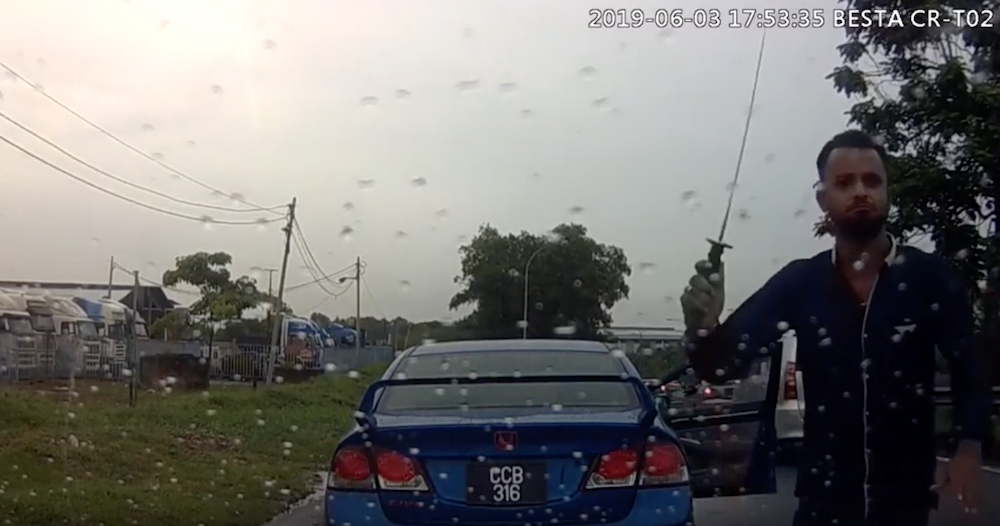 A screengrab from YouTube of a man attacking a car with a parang along the Pasir Gudang Highway June 3, 2019.