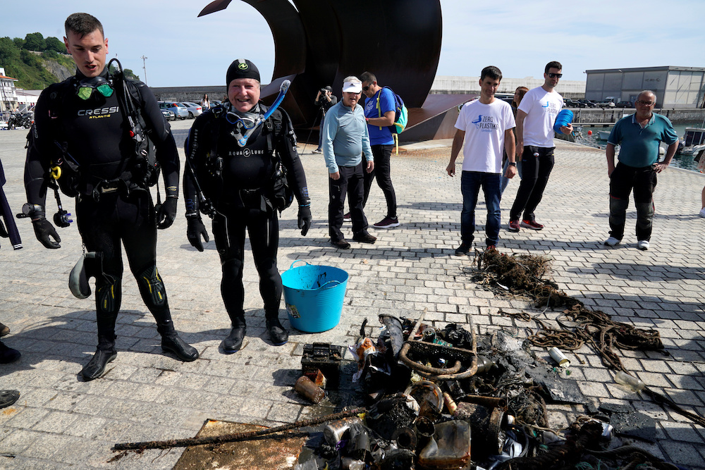 Divers stand next to plastic waste taken from the port, in the Zero Plastiko Urdaibai ocean and coastal cleanup near Bermeo, Spain June 8, 2019. u00e2u20acu201d Reuters picnn