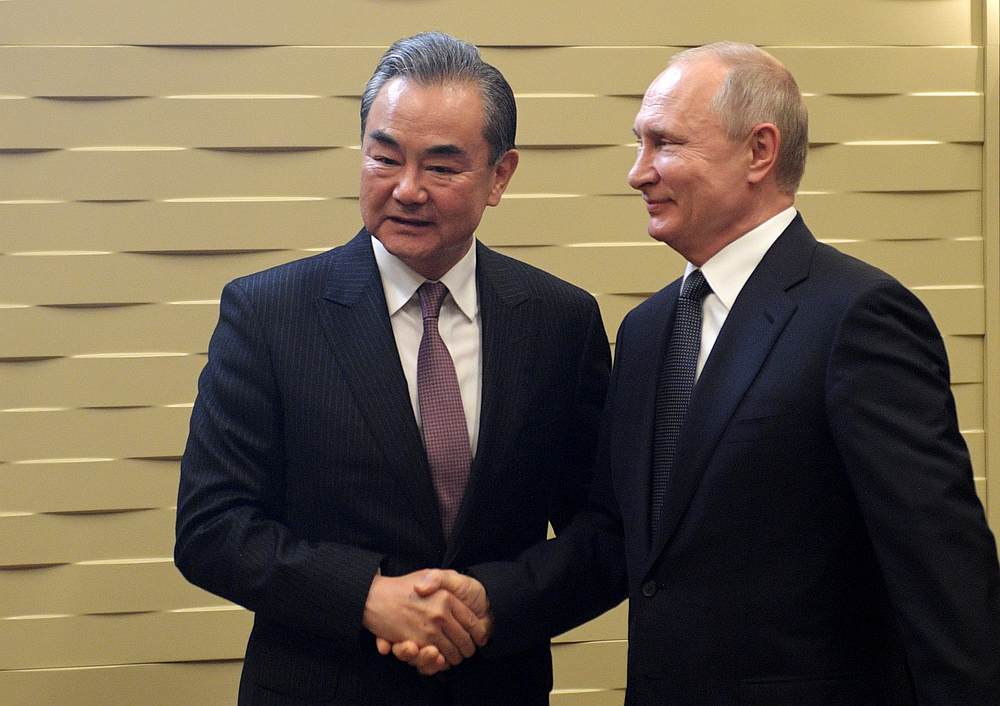 Chinese Foreign Minister Wang Yi shakes hands with Russian President Vladimir Putin during a meeting in Sochi, Russia May 13, 2019. u00e2u20acu201d Sputnik/Alexei Druzhinin/Kremlin pic via Reuters