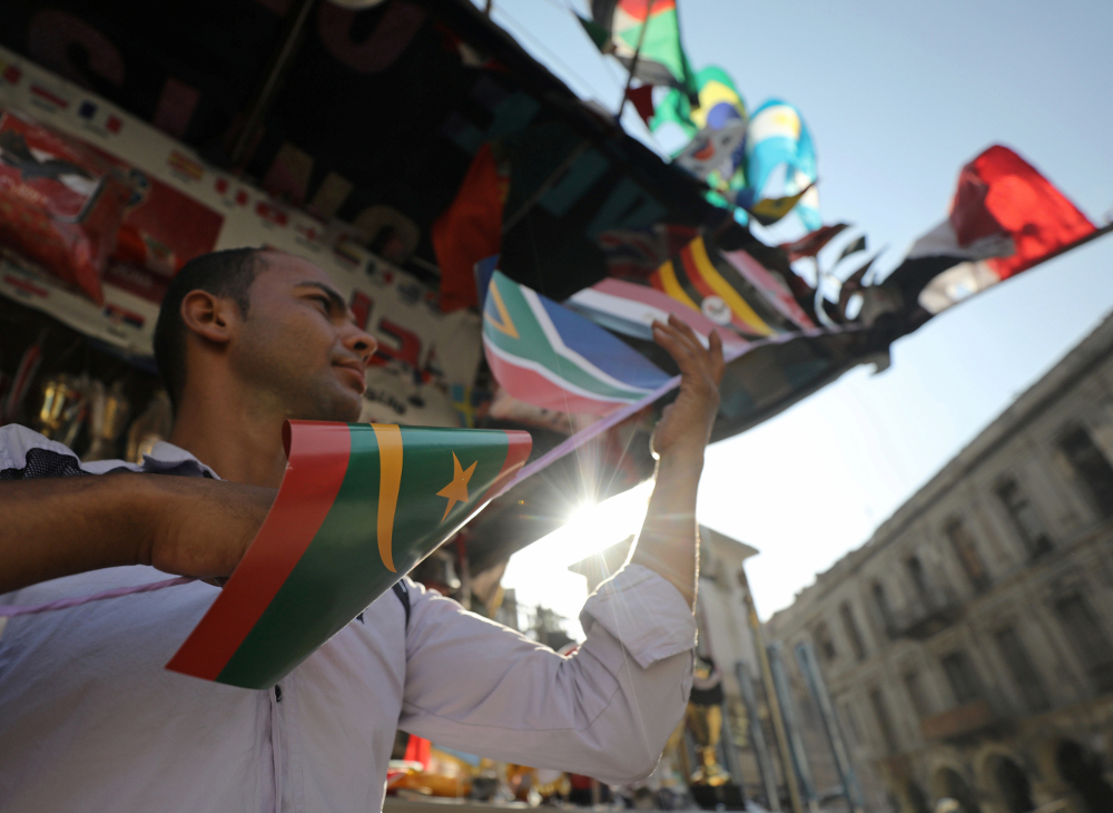 A man sells flags of African countries at a shop in preparation for the Africa Cup of Nations, at Al Ataba in Cairo June 16, 2019. u00e2u20acu201d Reuters pic
