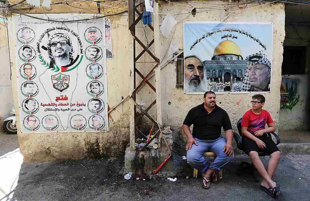 People sit together near banners at Shatila refugee camp in Beirut, Lebanon June 24, 2019. u00e2u20acu201d Reuters pic