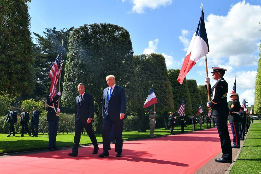 French President Emmanuel Macron and US President Donald Trump walk on the red carpet during a French-US ceremony at the Normandy American Cemetery and Memorial in Colleville-sur-Mer, Normandy, France, on June 6, 2019. u00e2u20acu201d AFP pic