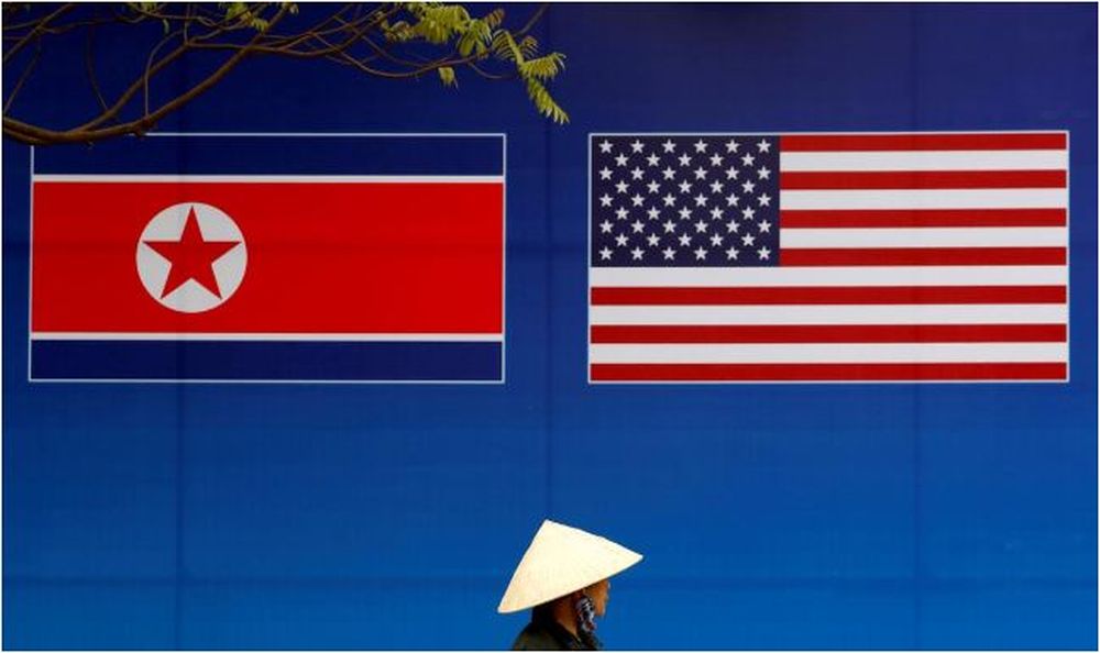 A person walks past a banner showing North Korean and US flags ahead of the North Korea-US summit in Hanoi, Vietnam, February 25, 2019. u00e2u20acu201d Reuters pic