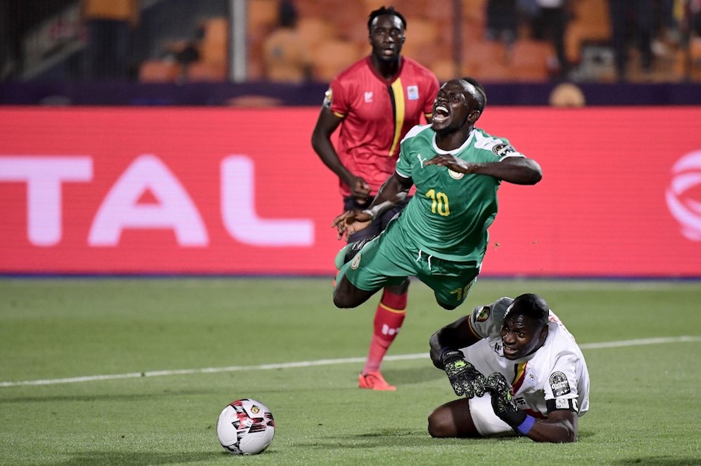 Ugandau00e2u20acu2122s goalkeeper Denis Onyango fouls Senegalu00e2u20acu2122s forward Sadio Mane during the 2019 Africa Cup of Nations round of 16 match at the Cairo International Stadium July 5, 2019. u00e2u20acu201d AFP pic