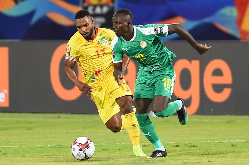 Senegalu00e2u20acu2122s forward Sadio Mane is marked by Beninu00e2u20acu2122s midfielder Stephane Sessegnon during their 2019 Africa Cup of Nations (CAN) quarter-final match in Cairo July 9, 2019. u00e2u20acu201d AFP pic