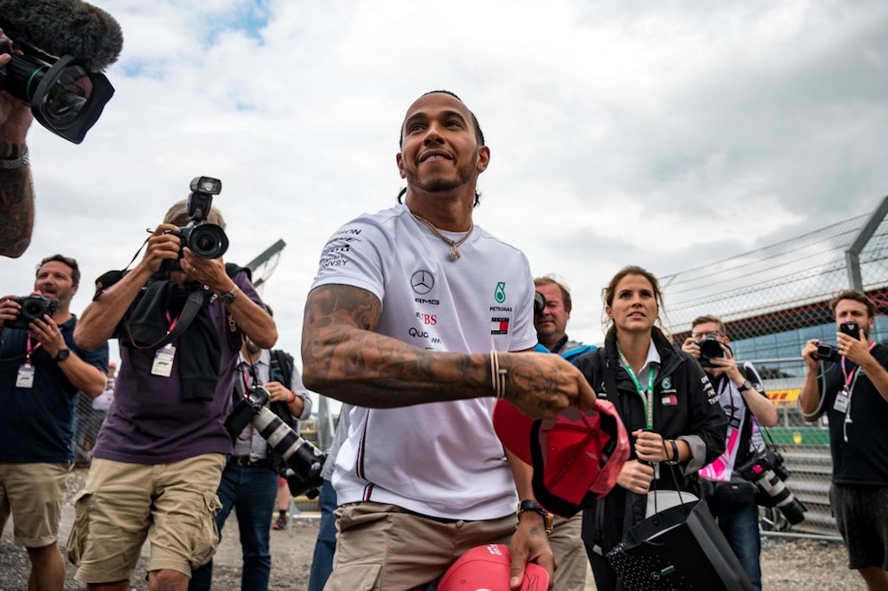 Mercedesu00e2u20acu2122 British driver Lewis Hamilton throws signed caps to his fans at the Silverstone motor racing circuit in Silverstone July 11, 2019, ahead of the British Formula One Grand Prix. u00e2u20acu201d AFP pic
