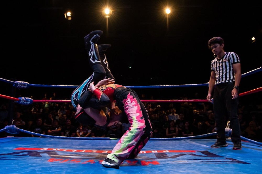 The hijab-wearing Malaysian wrestler known as Nor ‘Phoenix’ Diana wrestles with a male opponent during a match organised by Malaysia Pro Wrestling in Kuala Lumpur July 6, 2019. — AFP pic