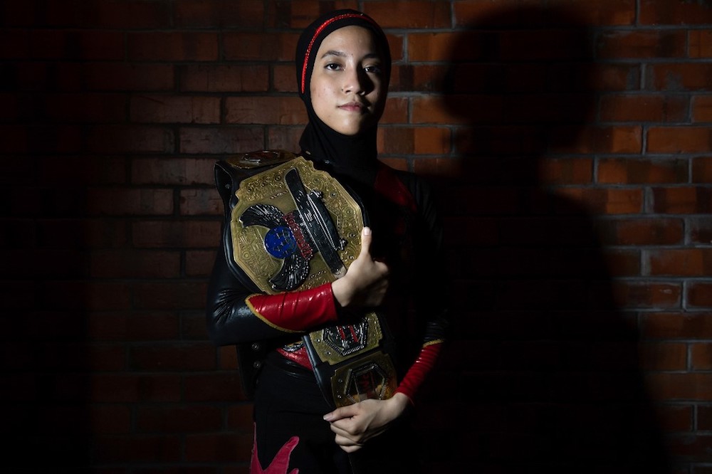 The hijab-wearing Malaysian wrestler known as Nor u00e2u20acu02dcPhoenixu00e2u20acu2122 Diana poses for pictures with the Wrestlecon championship belt in Kuala Lumpur July 6, 2019. u00e2u20acu201d AFP pic