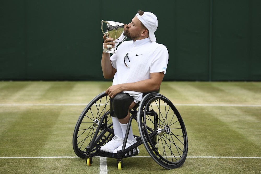 Australiau00e2u20acu2122s Dylan Alcott celebrates with the trophy after winning the quad wheelchair singles final against Britainu00e2u20acu2122s Andy Lapthorne at the 2019 Wimbledon Championships in London July 13, 2019. u00e2u20acu201d AFP pic