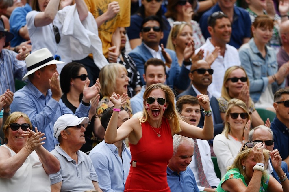 A Federer fan celebrates as Switzerlandu00e2u20acu2122s Roger Federer breaks the serve of Serbiau00e2u20acu2122s Novak Djokovic in the fifth set during the menu00e2u20acu2122s singles final at the 2019 Wimbledon Championships in London July 14, 2019. u00e2u20acu201d AFP pic