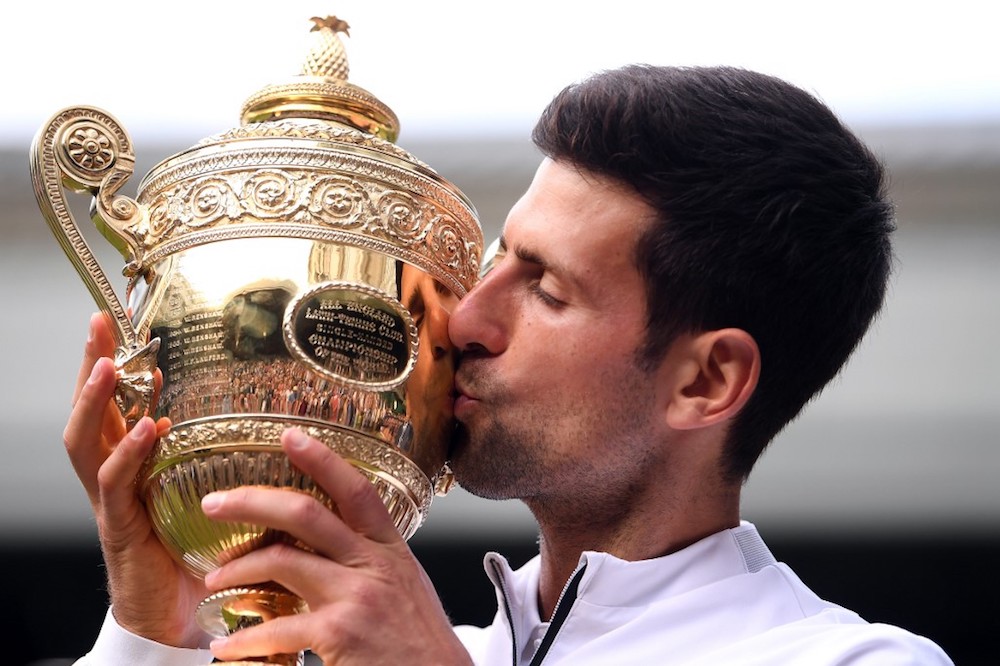 Serbiau00e2u20acu2122s Novak Djokovic kisses the winneru00e2u20acu2122s trophy after beating Switzerlandu00e2u20acu2122s Roger Federer during their menu00e2u20acu2122s singles final at the 2019 Wimbledon Championships in London July 14, 2019. u00e2u20acu201d AFP pic