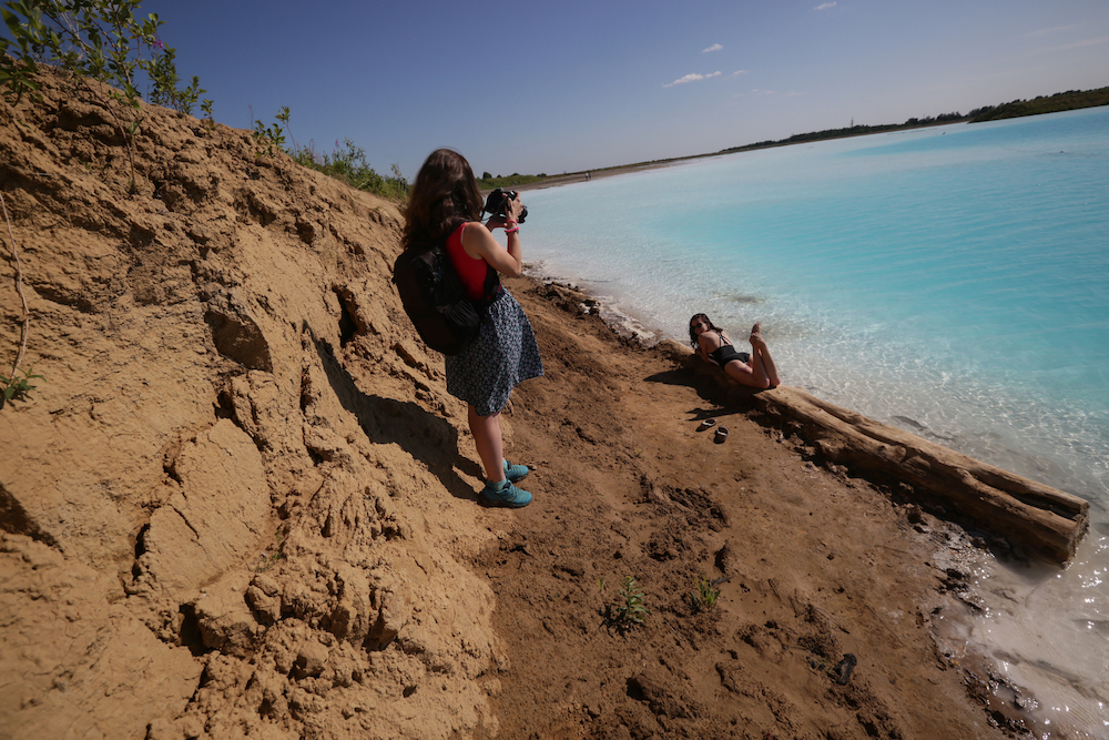 A young woman poses for pictures by a Novosibirsk energy plant's ash dump site u00e2u20acu201d nicknamed the local 'Maldives.' u00e2u20acu201d AFP pic