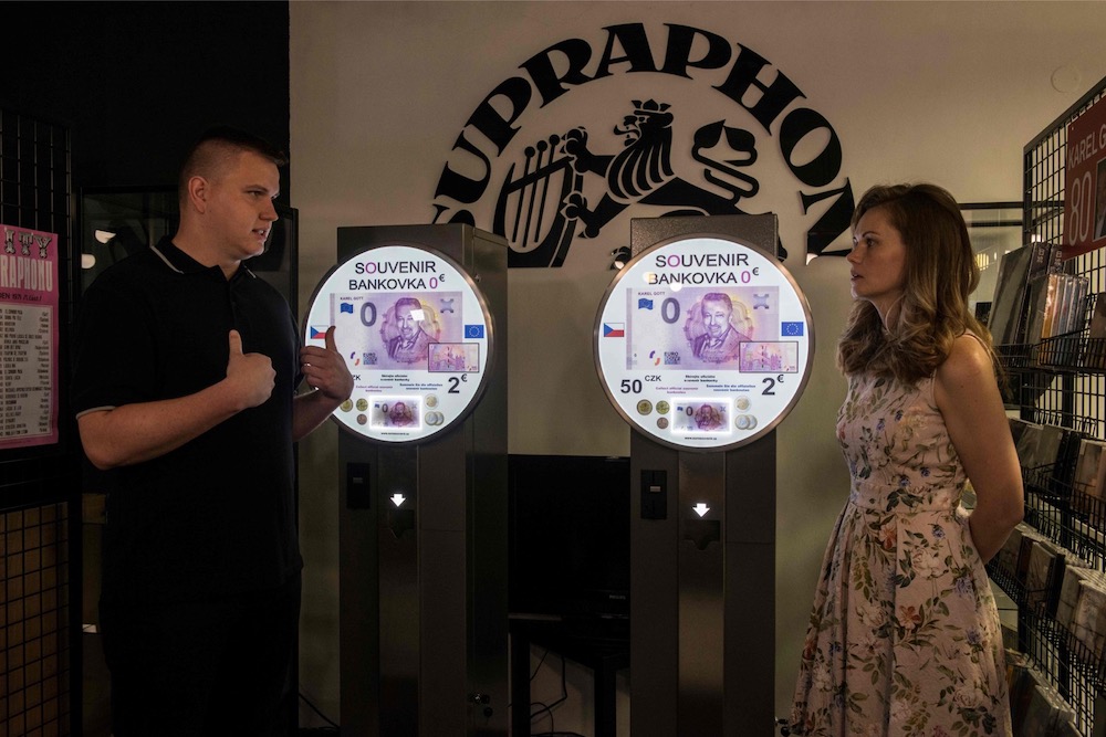 A couple guard the ATM selling a u00e2u20acu02dcZero Eurou00e2u20acu2122 souvenir banknote depicting Czech pop singer Karel Gott in honour of his 80th birthday on July 14, 2019 at the shop of a local record company, in Prague. u00e2u20acu201d AFP pic