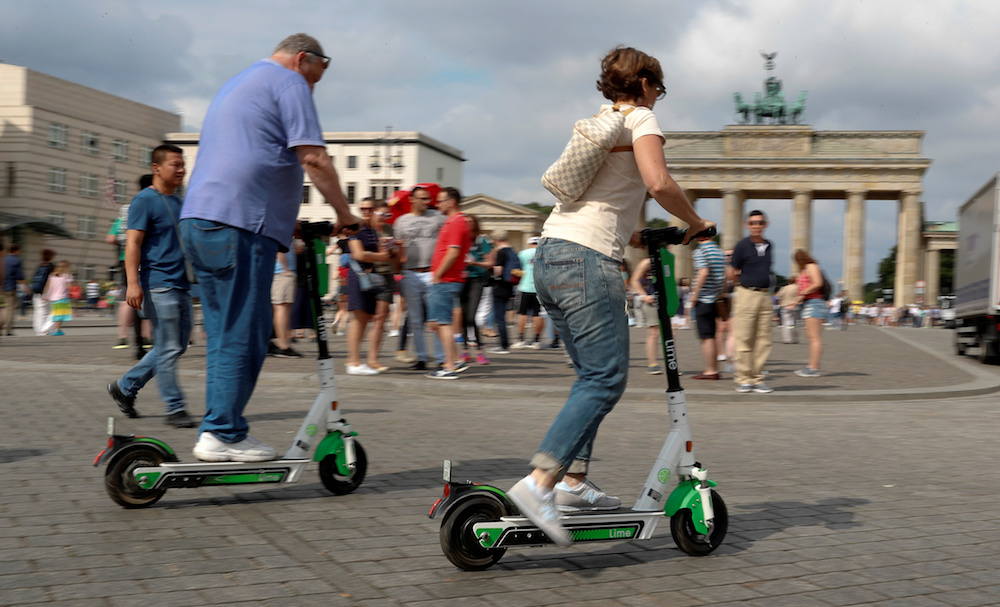 People use electric scooters by California-based bicycle rental service Lime at the Brandenburg Gate in Berlin June 21, 2019. u00e2u20acu201d Reuters pic