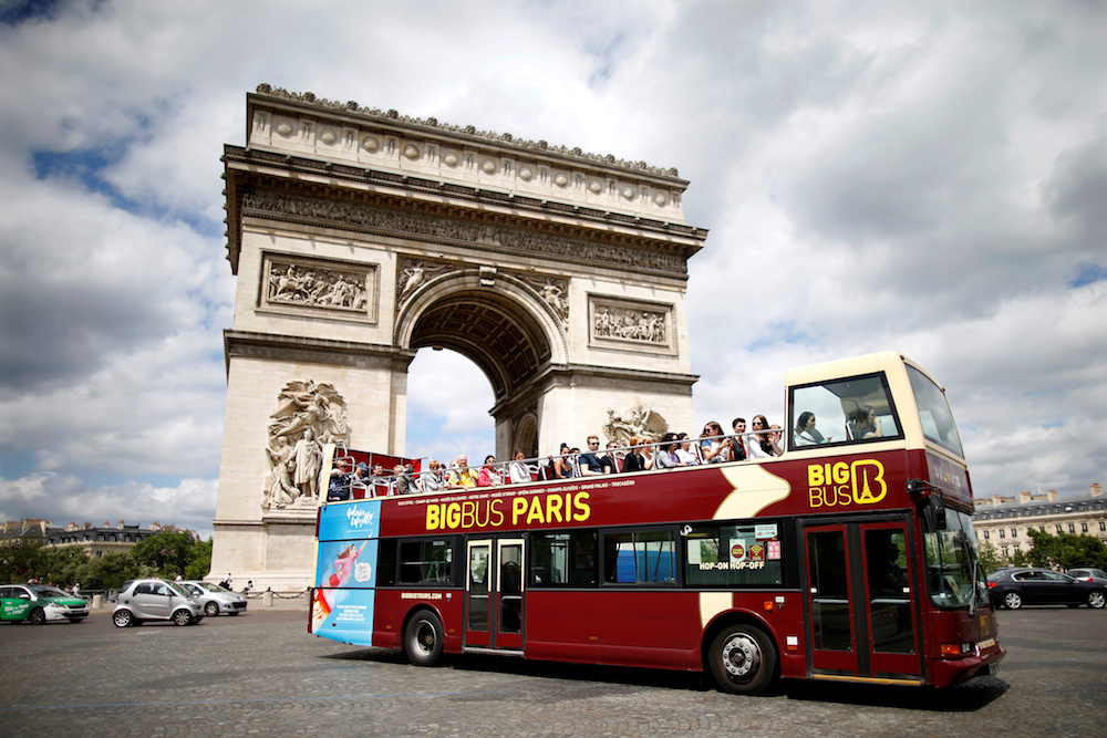 Tourists ride in an open-air double-decker bus past the Arc de Triomphe in Paris May 30, 2017. u00e2u20acu201d Reuters pic