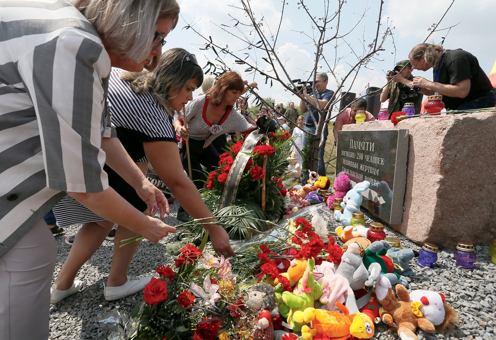 People place flowers and toys at a memorial to victims of the Malaysia Airlines Flight MH17 plane crash during a ceremony marking the fifth anniversary of the accident near the village of Hrabove in Donetsk Region, Ukraine July 17, 2019. u00e2u20acu201d Reuters pic