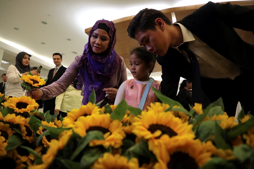 People take sunflowers during a commemoration ceremony in memory of the victims of the Malaysia Airlines flight MH17 plane crash on the fifth anniversary of the accident, at the Australian High Commission in Kuala Lumpur July 17, 2019. u00e2u20acu201d Reuters pic