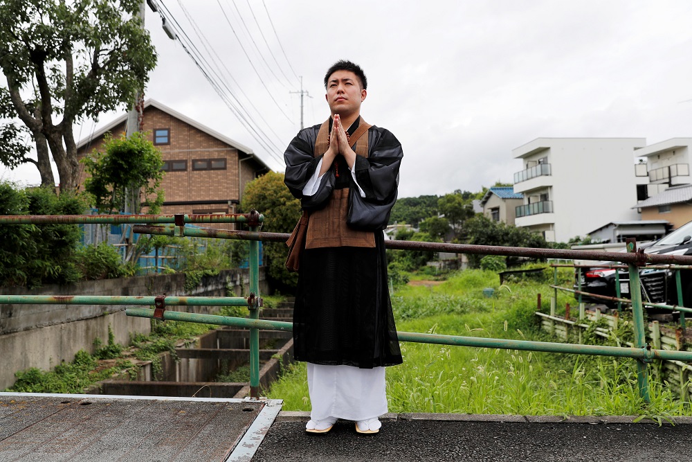 A Buddhist monk prays near the Kyoto Animation building which was torched by arson attack, in Kyoto July 19, 2019. u00e2u20acu201d Reuters pic