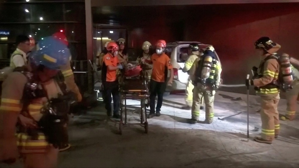 Rescue workers place a man, who had set himself on fire in an apparent protest, onto a stretcher in Seoul July 19, 2019, in this still image taken from video. u00e2u20acu201d Handout by Jongno Fire Station via Reuters