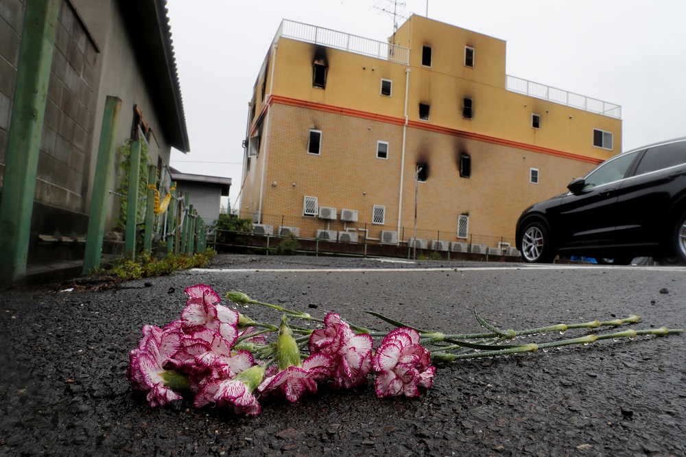 Flowers are placed in front of the torched Kyoto Animation building to mourn the victims of the arson attack in Kyoto July 19, 2019. — Reuters pic