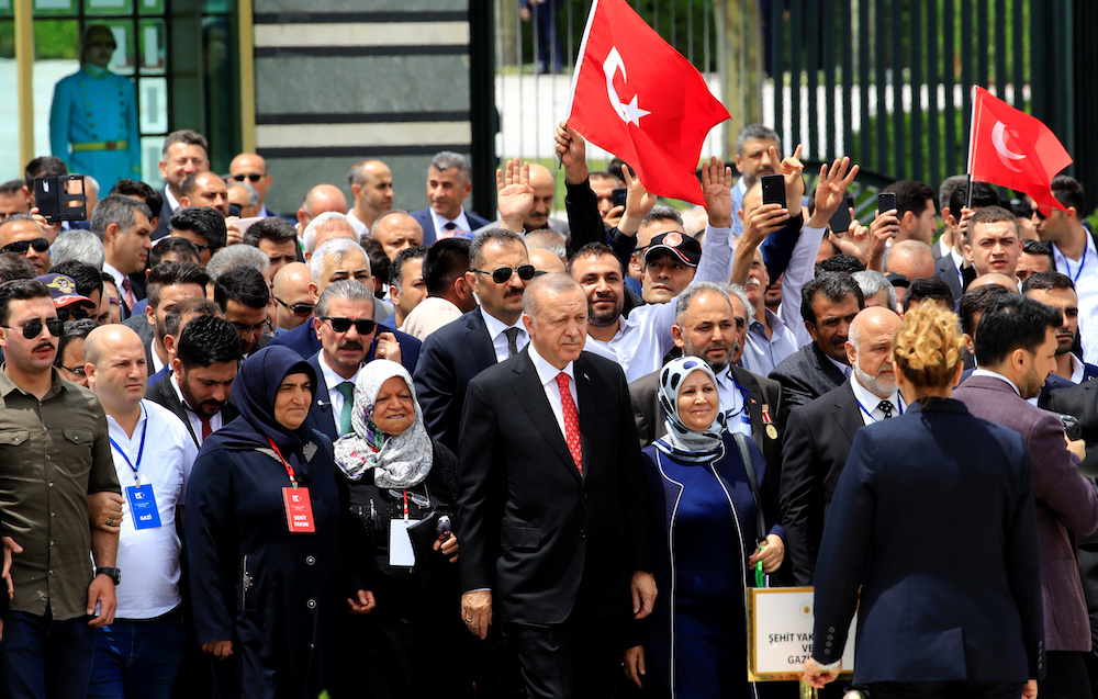 Turkish President Tayyip Erdogan visits a monument as he is flanked by his supporters during a ceremony marking the third anniversary of the attempted coup, at the Presidential Palace in Ankara July 15, 2019. u00e2u20acu201d Reuters picnn