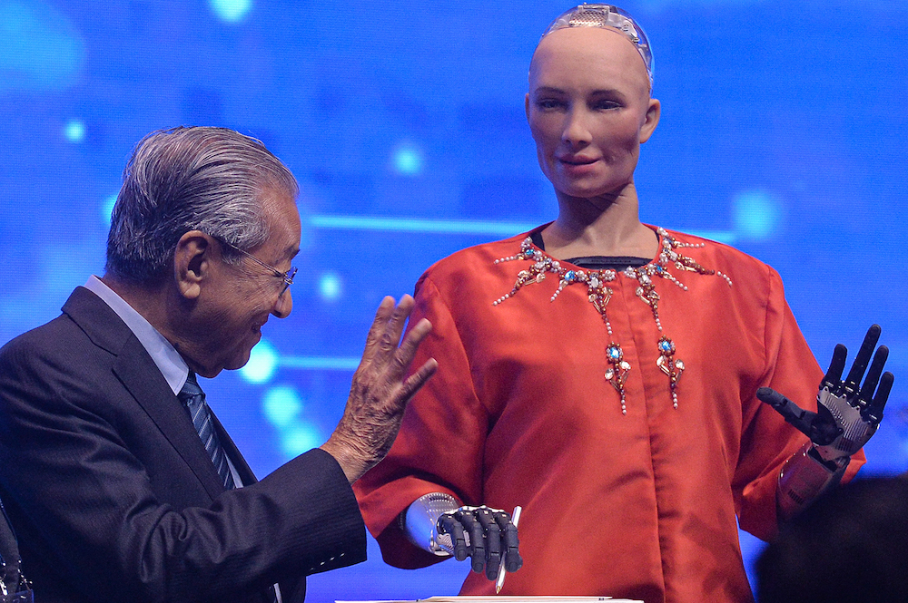 Prime Minister Tun Dr Mahathir Mohamad interacts with humanoid robot Sophia during the u00e2u20acu02dcBeyond Paradigm Summit 2019u00e2u20acu2122 in Kuala Lumpur July 17, 2019. u00e2u20acu201d Picture by Mukhriz Hazim