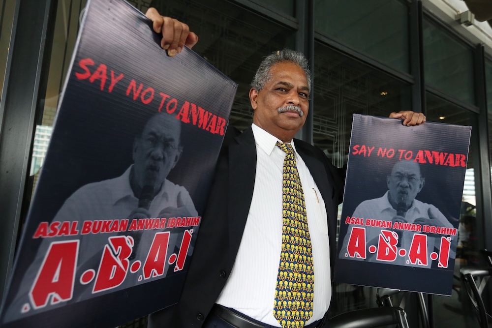 Ganapathy Ponnusamy holds placards with his new slogan u00e2u20acu02dcABAI u00e2u20acu201d Asalkan Bukan Anwar Ibrahimu00e2u20acu2122 during a press conference in Kuala Lumpur July 19, 2019. u00e2u20acu201d Picture by Choo Choy May