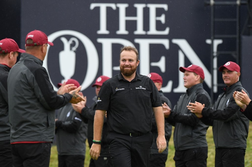Irelandu00e2u20acu2122s Shane Lowry is applauded by staff as he arrives to collect the Claret jug after winning the British Open Golf Championships at Royal Portrush golf club in Northern Ireland July 21, 2019. u00e2u20acu201d AFP pic