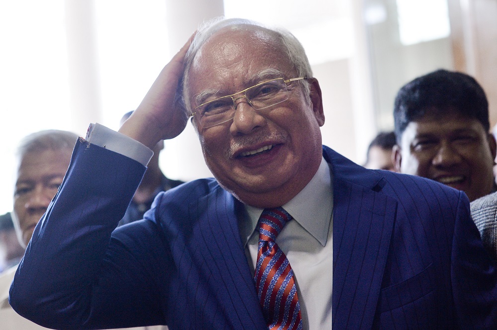 Datuk Seri Najib Razak smiles after being presented with a birthday cake at the lobby of the Kuala Lumpur Court Complex July 23, 2019. u00e2u20acu201d Picture by Mukhriz Hazim 