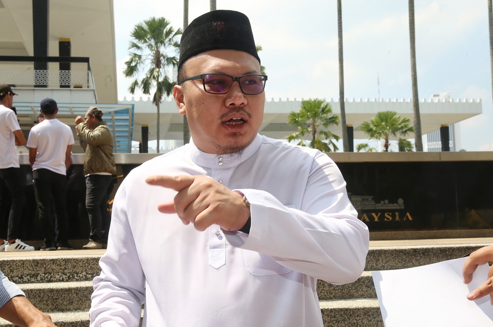 Umno Youth exco Muhammad Faiz Hashim speaks to the press during a protest Attorney General Tommy Thomas in front of the National Mosque in Kuala Lumpur July 26, 2019. u00e2u20acu201d Picture by Choo Choy May