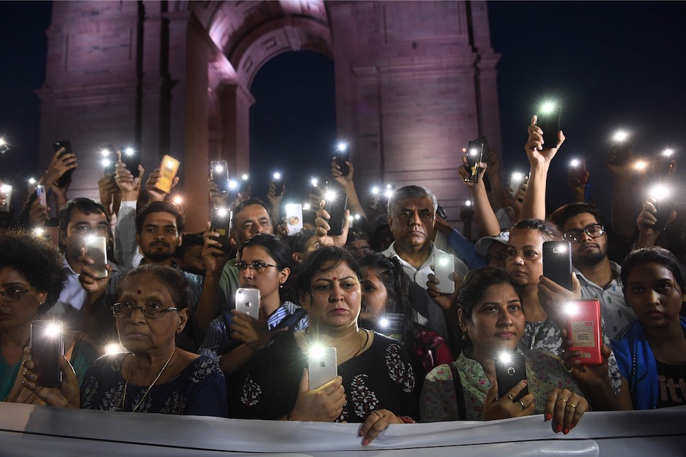 Indian social activists use their mobile light as they take part in a solidarity rally in front of India Gate monument for the Unnao rape victim in New Delhi July 29, 2019. u00e2u20acu201d AFP pic