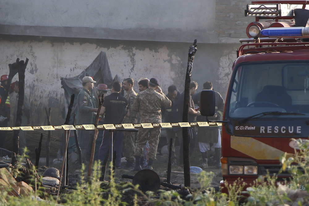 Rescue workers and army soldiers gather at the site after a military aircraft on a training flight crashed in a built-up area in the garrison city of Rawalpindi July 30, 2019. u00e2u20acu201d Reuters pic