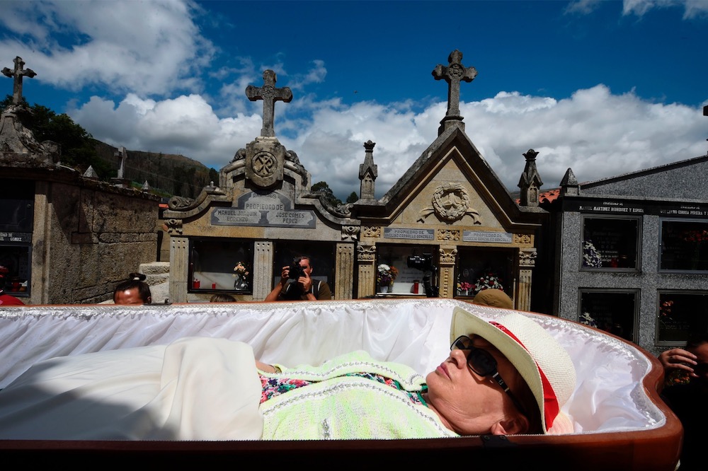 A woman is carried in a coffin by relatives during the annual u00e2u20acu02dcProcession of the Shroudsu00e2u20acu2122 to celebrate Saint Martha u00e2u20acu02dcthe Saint of resurrectionu00e2u20acu2122 in the village of Santa Marta de Ribarteme, near Nieves July 29, 2019. u00e2u20acu201d AFP pic