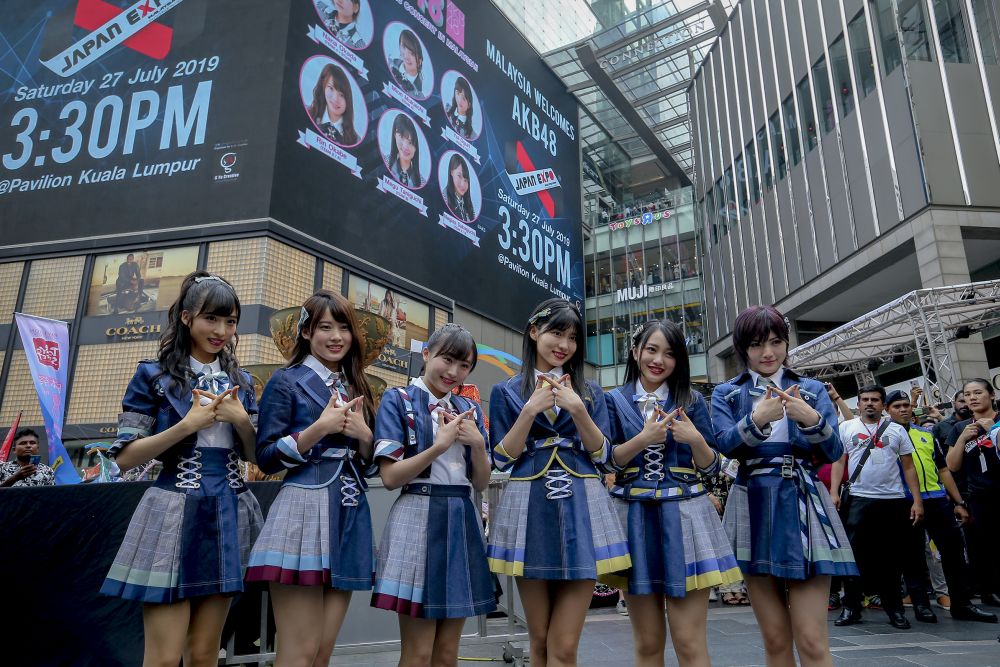 The members strike a pose outside Pavilion, Kuala Lumpur just before their performance. — Picture by Firdaus Latif