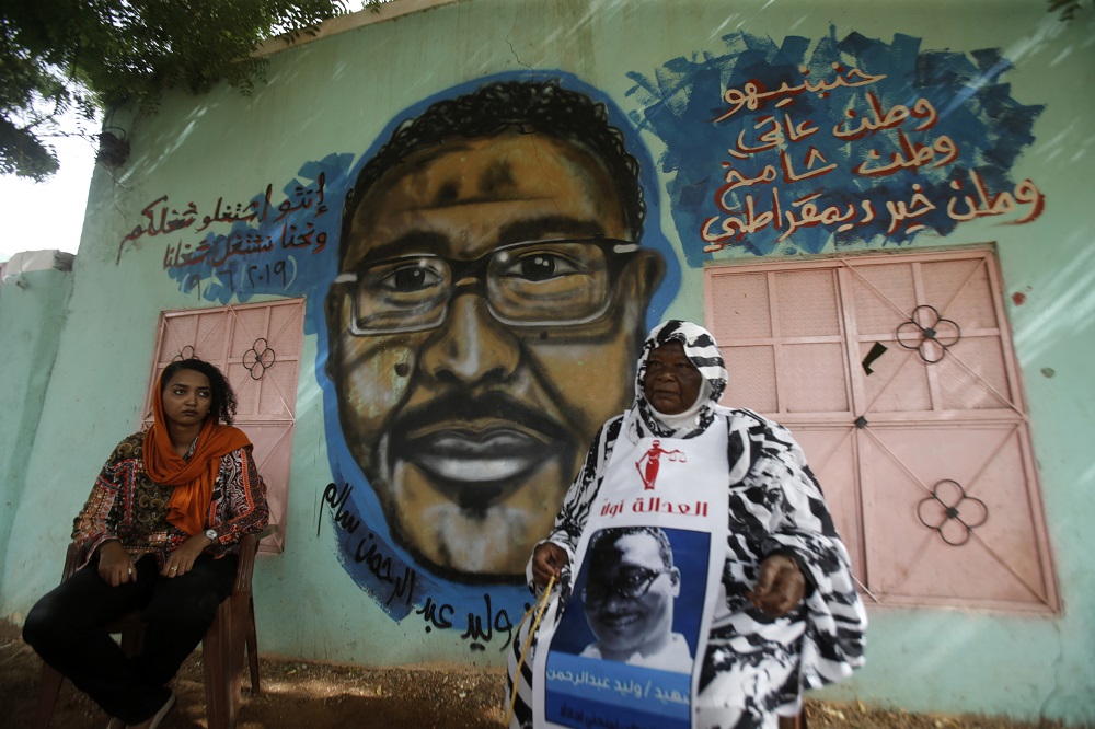 Maiyssa Omar (right), the mother of Walid Abdelrahim and Sudanese artist Assil Diab, sit in front of the mural painting of Abdelrahim in the family home in the capital Khartoum July 21, 2019. u00e2u20acu201d AFP pic        