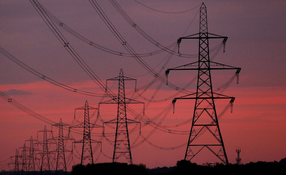 The sun rises behind electricity pylons near Chester, northern England October 24, 2011. u00e2u20acu201d Reuters pic 
