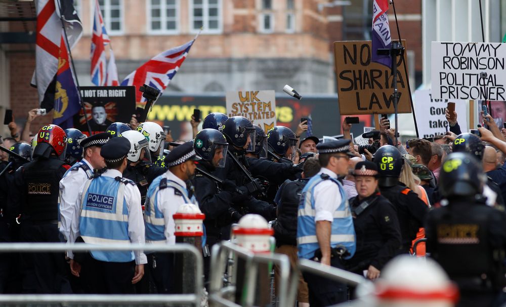 Riot police stands next to supporters of far-right activist Stephen Yaxley-Lennon, who goes by the name Tommy Robinson, outside the Old Bailey court in London, July 11, 2019. u00e2u20acu201d Reuters pic