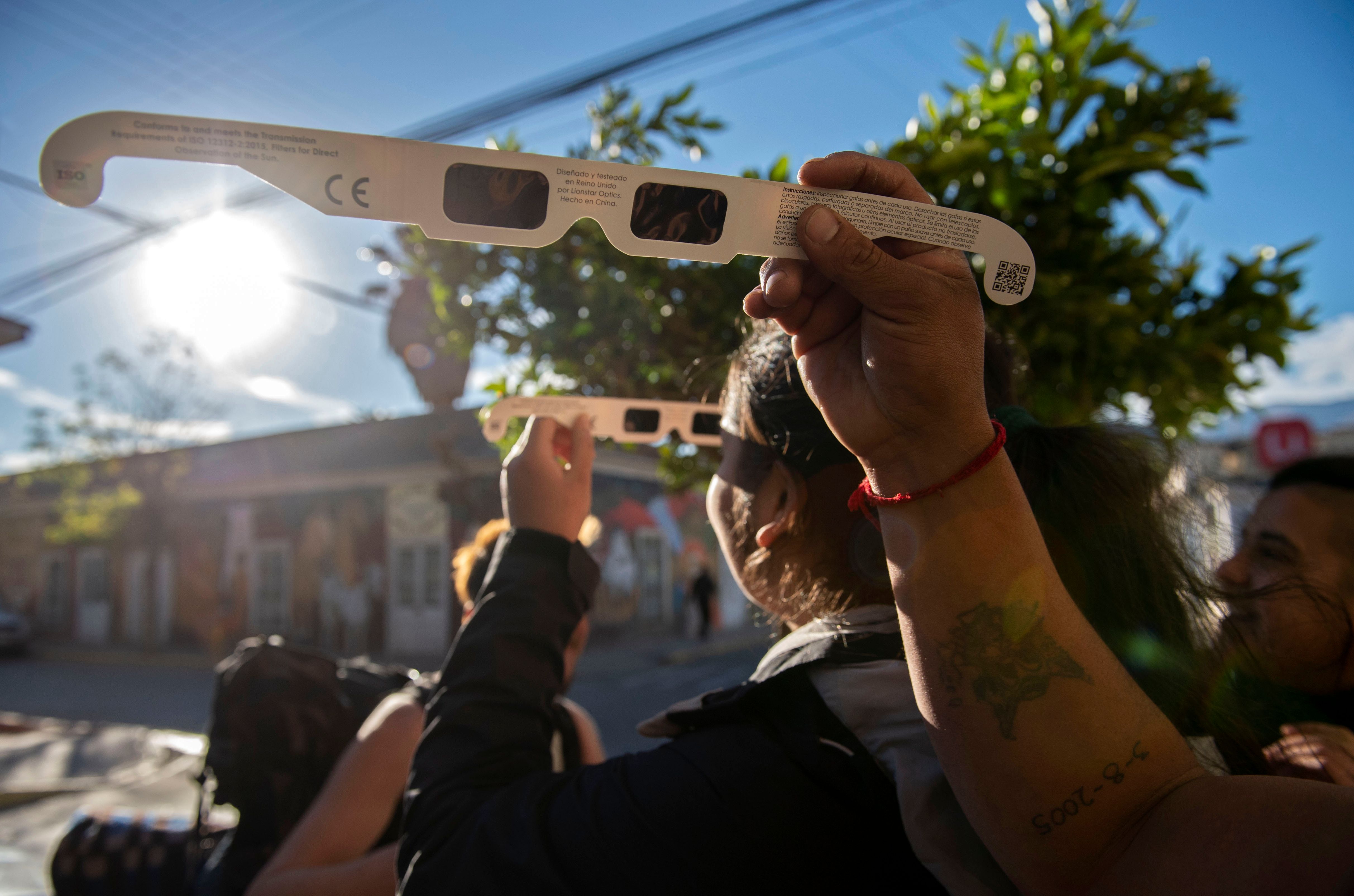 Tourists look at the sun through solar glasses before a solar eclipse in Vicuna, Valle del Elqui, Coquimbo region, in Atacama desert, about 500km north of Santiago, Chile June 30, 2019. u00e2u20acu201d AFP pic          