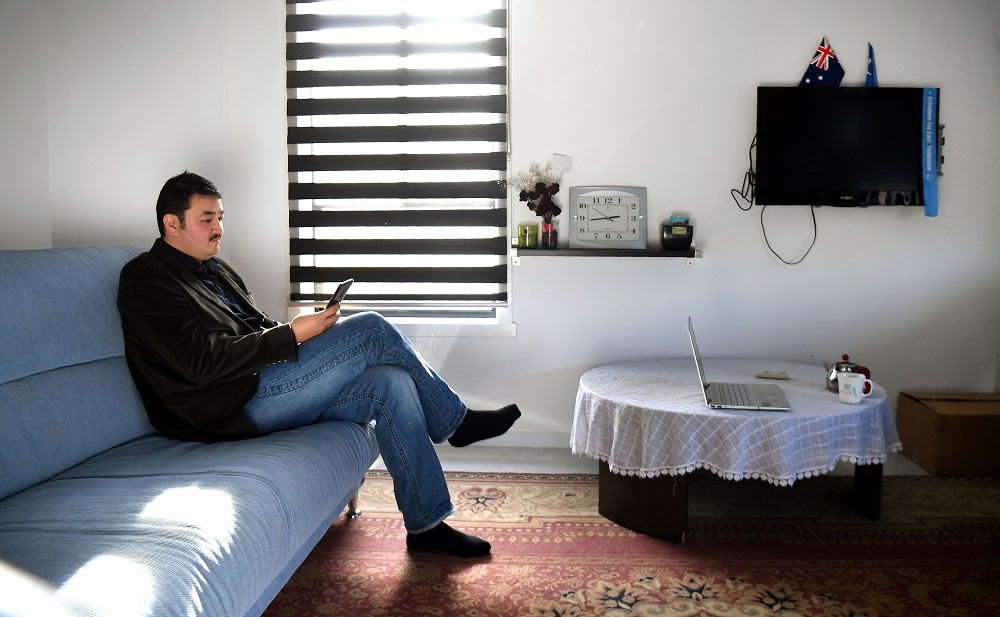 This photo taken on July 6, 2019 shows 32-year-old Melbourne-based Uighur refugee Shir Muhammad Hasan inspecting messages on his phone at his Melbourne home. u00e2u20acu201d AFP pic       