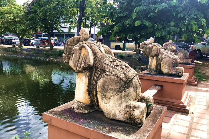 Statues of elephants stand guard over the canals of the Old City moat.