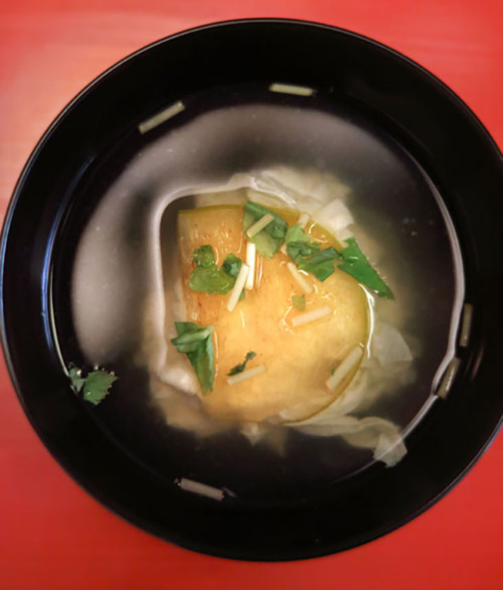 Smooth and silky – a clear soup of 'yuba' (tofu skin) topped with sweet 'kaki' (persimmon)