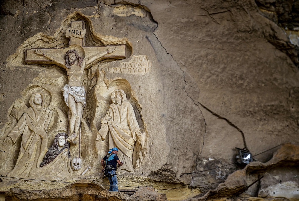 Polish artist Mario, sculptor of St Simon the Tanner Monastery complex, works on a scene relief depicting the Crucifixion of Jesus Christ, at the church in the Egyptian capital Cairou00e2u20acu2122s eastern hillside Mokkatam district May 30, 2019. u00e2u20acu201d AFP pic        